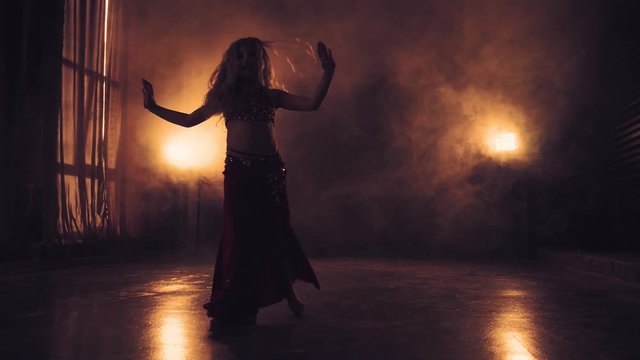 Silhouettes of belly dancer dancing