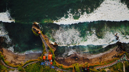 Tanah Lot Temple in Kediri with big waves crushing the cliffs, Bali, Indonesia
