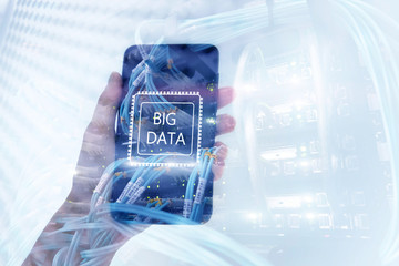 Big Data concept with hand holding modern smart phone. Server room background.