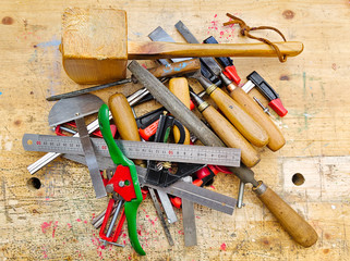 Various woodworking hand tools on workbench.