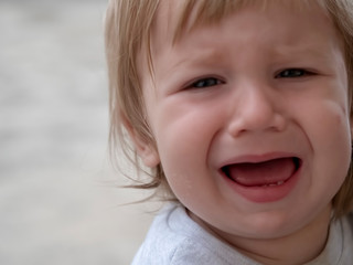 Close-up Emotional expression of a crying child    Fair-haired child close-up emotional crying boy European