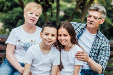 Fototapeta premium Grandparents and grandchildren enjoying day together on nature.
