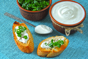 Croutons with sour cream and greens. Chopped green onions and sour cream. Sour cream. Fermented milk product. Probiotics.