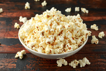 bowl of salty popcorn on wooden table