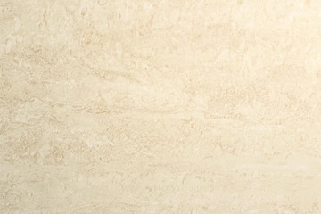 Beige tile texture on the wall. Abstract stains on tile. Close-up view.