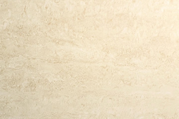 Beige tile texture on the wall. Abstract stains on tile. Close-up view.
