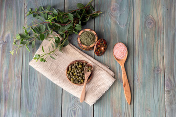 Capers on a wooden plate