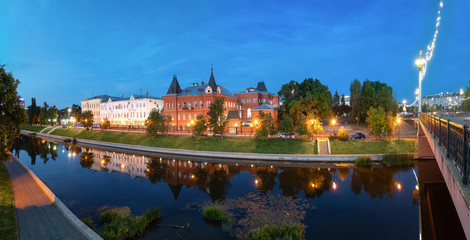 Fototapeta na wymiar Oryol, Russia. Panorama of Orlik river embankment at dusk with old historic buildings