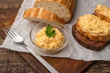 Cooking exits. Sandwiches with grated cheese on white bread. Wooden background
