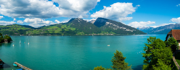 Spiez, Switzerland - May 30th 2019: People are sailing sailboat at Thun Lake, Spiez Switzerland