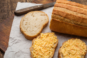 grated cheese sandwich with garlic on a piece of white loaf. Cooking Snacks