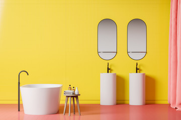 Bright yellow bathroom interior, tub and sinks