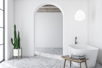 White arched bathroom interior with tub