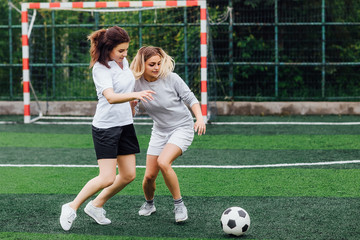Two, young female soccer players on the field. Activity and sport concept.