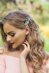 Beautiful woman with modern hairstyle and hair jewelry