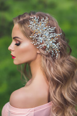 Beautiful woman with modern hairstyle and hair jewelry