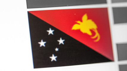 Papua new guinea national flag of country. flag on the display, a digital moire effect.