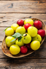 Fresh sweet plums on the wooden table