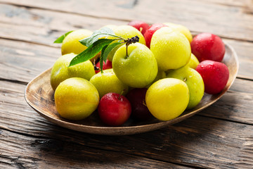 Fresh sweet plums on the wooden table