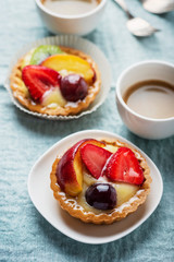 Mini tarts with cream and mix of summer fruit