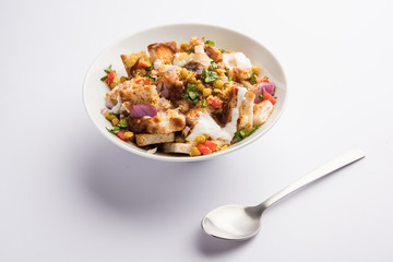 Bread chaat/chat is a yummy starter/appetizer from India, served in a bowl garnished with tomato, sev and coriander and masala. selective focus