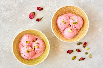 Strawberry rosewater ice cream , frozen yogurt with pistachio and rosebud. Top view