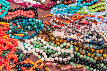 Beads from semiprecious stones. Indian jewelry on the shop counter.