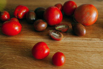 Naklejka na ściany i meble Freshly collected tomatoes on the kitchen table