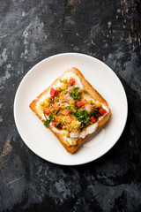 Bread ppadi chaat/chat is a yummy starter/appetizer from India, served in a plate garnished with tomato, sev and coriander and masala. selective focus