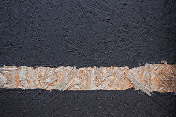 Wood splinter wall painted black with stripe in natural wood