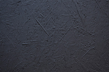 Texture of a wood splinter pressed wall, painted black
