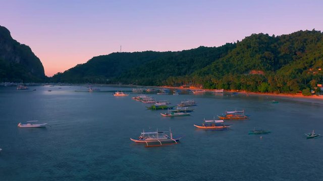 Sail boats at sunset on the sea lagoon on Corong beach in El Nido, Palawan, Philippines.