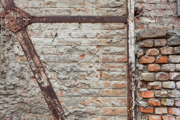 Rusty Metal beams support system for old brick walls