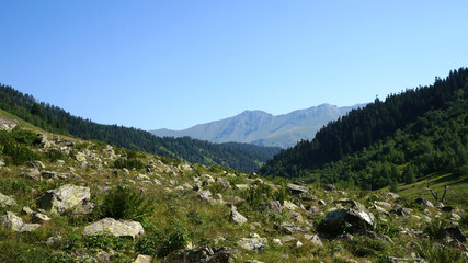 Landscape of Caucasus mountains. The rocks below. Stones lie at the bottom
