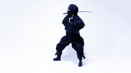 Ninja in black clothes with sword and shuriken
