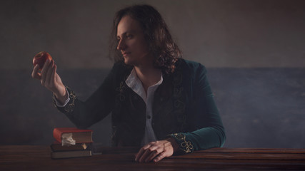 History of science, concept. Isaac Newton with Apple in hand