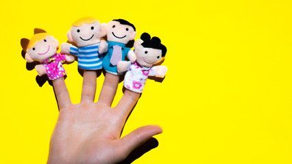 Puppet theater. Hand wearing finger family members puppets: mum, dad, father, mom, daughter, son. generation concept.