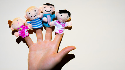 Puppet theater. Hand wearing finger family members puppets: mum, dad, father, mom, daughter, son....