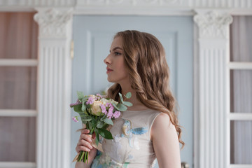 Beautiful and elegant girl in a lush and fashionable wedding dress.