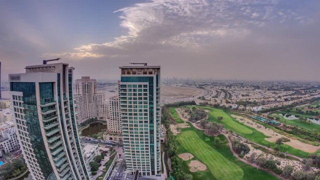Sunrise over towers in Greens district aerial view from top timelapse. Residential and office buildings from above near golf cource