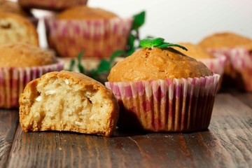 Vanilla cupcake, homemade pastry on wooden background