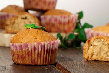 Vanilla cupcake, homemade pastry on wooden background