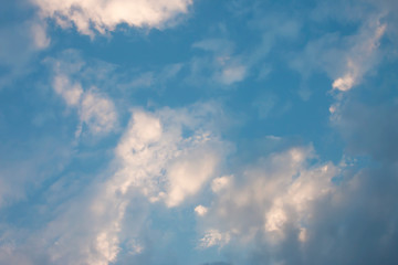 Blue sky with soft white clouds.