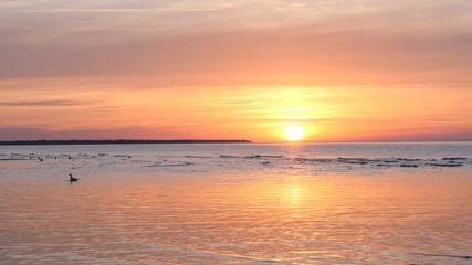 Obraz premium Beautiful fiery sunset sky on the beach. Composition of nature, Waves of the sea on a sandy beach.