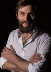 Portrait handsome bearded man, sexy guy on a dark background