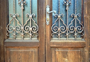 old wooden door with wrought iron grille