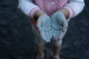 Children's hands are smeared with chalk.