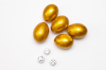 Golden eggs and dices. Concept of wealth, winnings, good luck