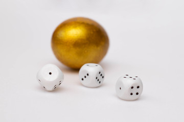 Golden egg and dices. The concept of wealth, luck, win