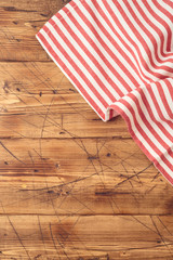 Wooden tabletop with striped tablecloth for kitchen or cooking food background. Top view from above